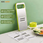 NHC MART multi-functional kitchen slicer and grater set with a stainless steel blade unit in lime green and white, shown standing on a countertop with several interchangeable blades laid out in front, a small matching green container, and sliced vegetables on a plate against a pale green wall.
