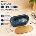 NHC MART portable ultrasonic cleaner machine in a dark teal-blue oval shape with a gold-toned lid, shown on a beige tabletop with decorative accessories and promotional text.