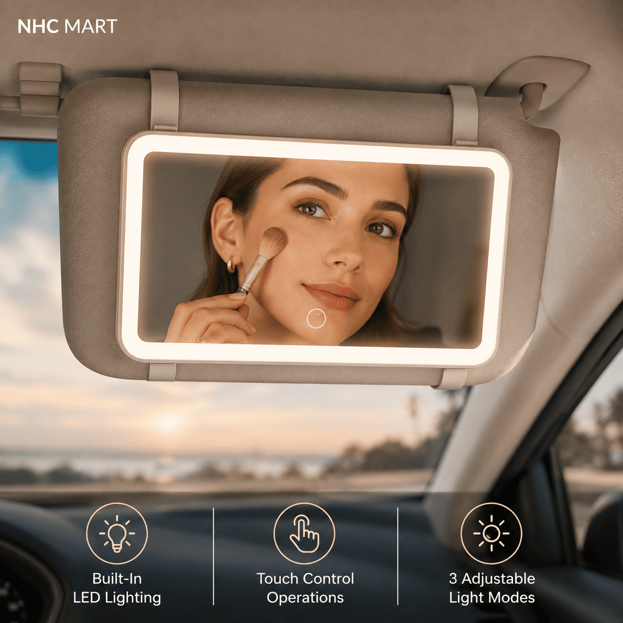 A car sun visor mirror with built-in LED lighting, shown mounted on a vehicle visor inside a car. A woman is visible in the mirror applying makeup.