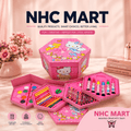 A pink Hello Kitty themed NHC Mart kids' art set displayed open to show its contents, including a paint palette, colored pencils, markers, and crayons, set against a soft pink background with decorative props.
