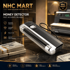 NHC Mart Money Detector cash counter device shown on a marble countertop with stacks of cash and a cash register in the background. The product is black and silver with a clear plastic outer shell and a small display screen.