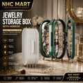 NHC Mart jewelry storage boxes with mirrors shown in a styled interior setting. The set includes a closed white rectangular box, two open dark green oval boxes with mirrored interiors displaying jewelry, and one closed dark green oval box on the right.