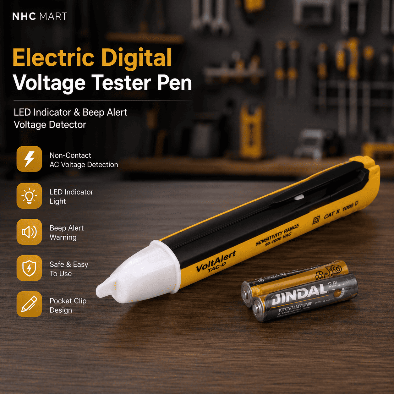 NHC MART Electric Digital Voltage Tester Pen in yellow and black with a white tip, shown alongside two Jindal AA batteries on a wooden workbench with a blurred workshop background.