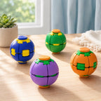 Four colorful spherical puzzle toys with segmented plastic pieces, displayed on a light wooden table in a bright indoor setting with a window, plant, and curtain in the background.