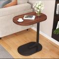 Wooden side table with black base in a living room setting