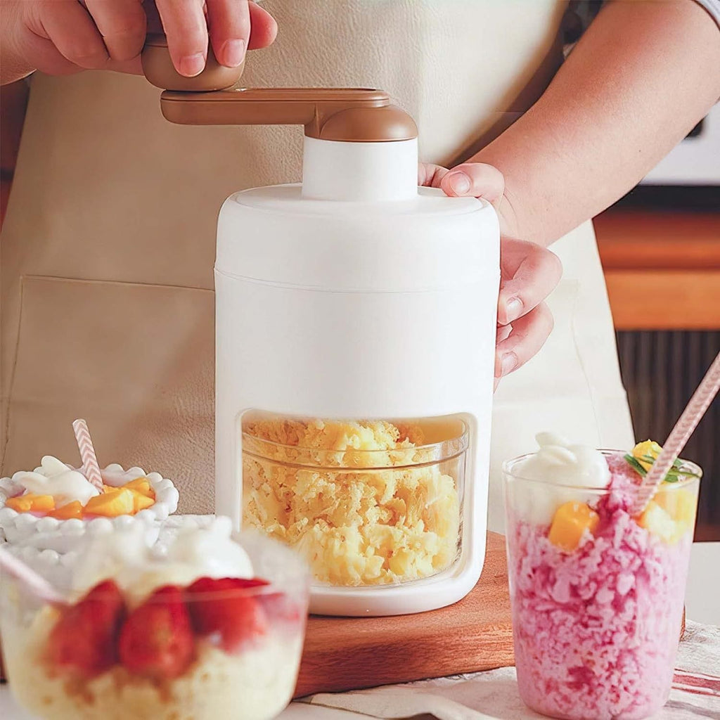 Manual ice shaver and ice crusher with stainless steel blades and hand crank for making crushed ice, snow cones, and cold drinks.
