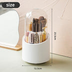 White cylindrical makeup organizer with brushes and a bottle, showing measurements on a neutral background.