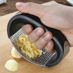 Manual stainless steel garlic press with ergonomic handle and silicone garlic peeler for crushing garlic and ginger