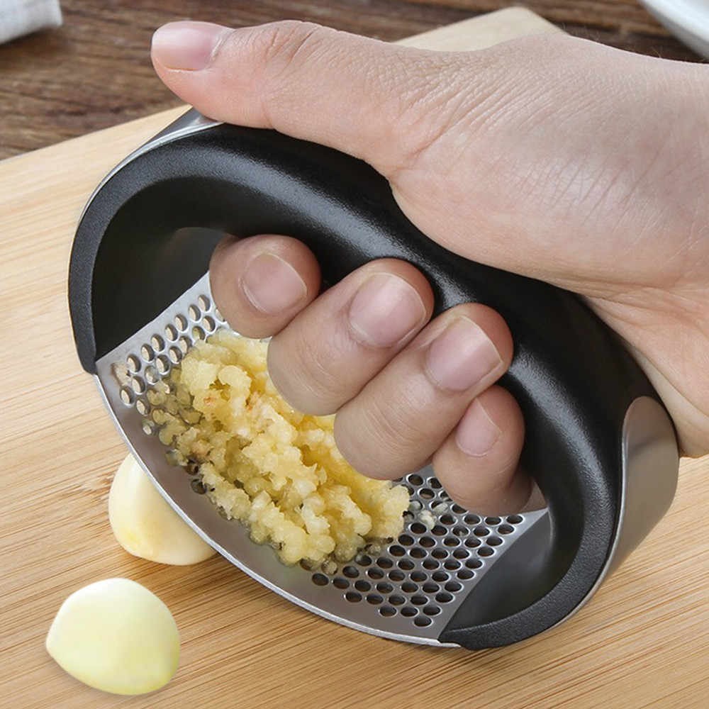 Manual stainless steel garlic press with ergonomic handle and silicone garlic peeler for crushing garlic and ginger