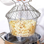 Metal strainer filled with food over a pot on a white background
