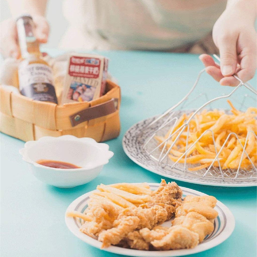 Two plates of food on a blue table with a person's hands and a basket in the background.